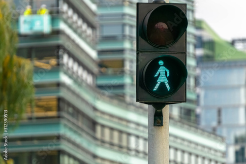 Green pedestrian signal to go. Traffic light female figure shape in Vilnius, Lithuania photo