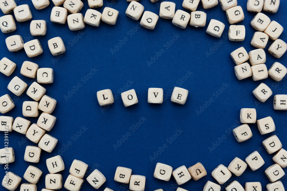Love is love message written on wooden blocks over blue background. Love is love message written on wooden blocks over blue background.