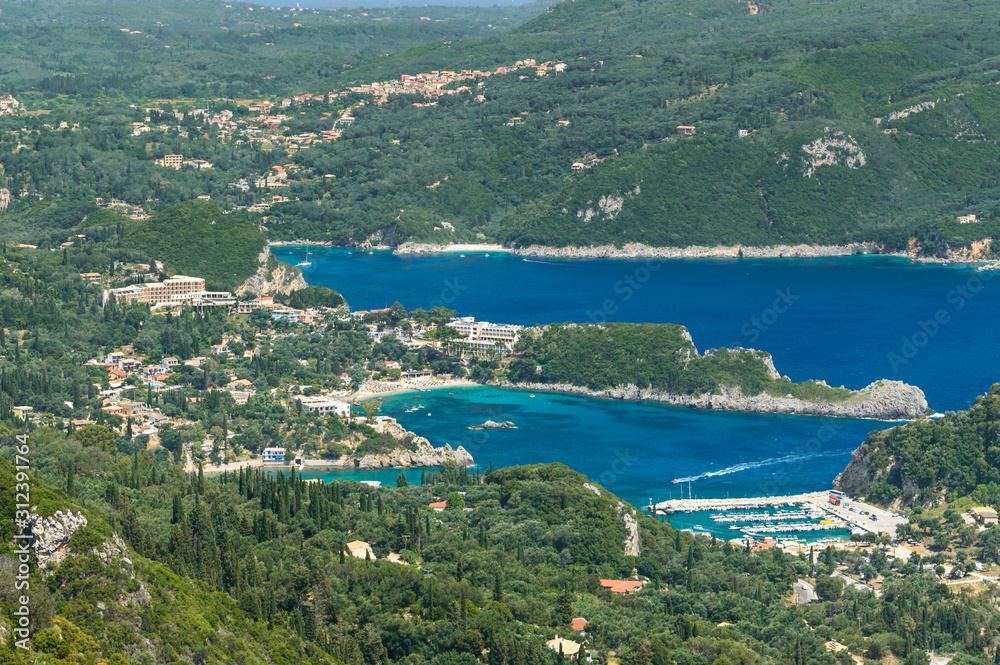 Stretching panorama from Angelokastro to the mountain bay of Paleokastritsa, below you can see the cliffs and the sea.