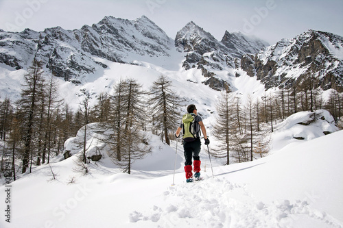 Winter landscape with mountaineer tracks in a beautiful sunny day. Gran Paradiso National Park, Italy