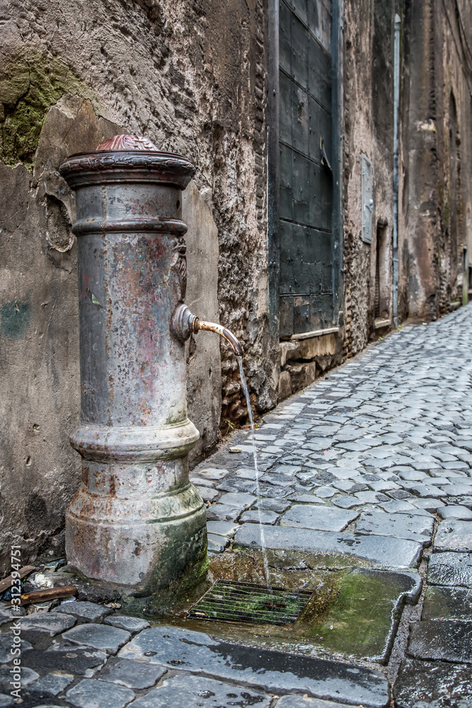 Drinking fountain on Coronari street in Rome. Lazio, Italy Drinking fountain on Coronari street in Rome. Lazio, Italy