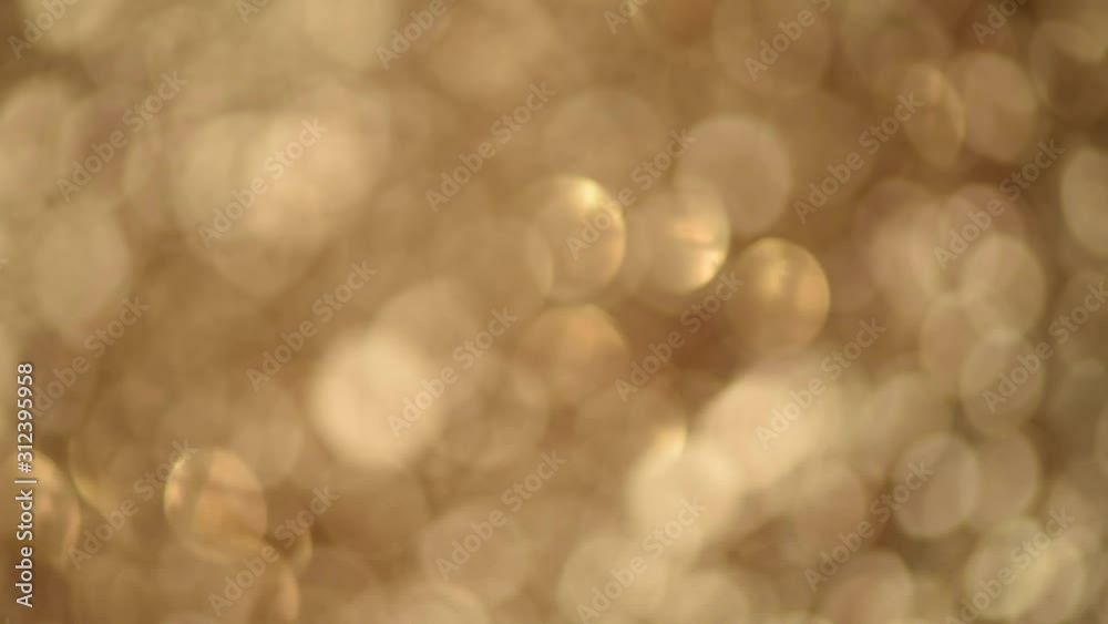 Sparkle glittering background. Holiday abstract texture. Christmas card with gold bokeh, defocused lights.