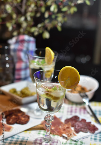 two martinis with lemon and ice slice