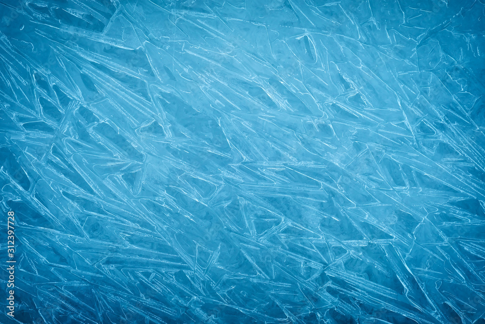 Obraz premium Background of blue cold winter ice. Texture of frozen surface. Frost pattern