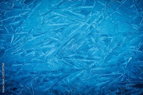 Background of blue cold winter ice. Texture of frozen surface. Frost pattern