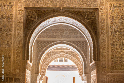 Ornate arches in a  Lions patio of Alhambra, Granada, Spain photo