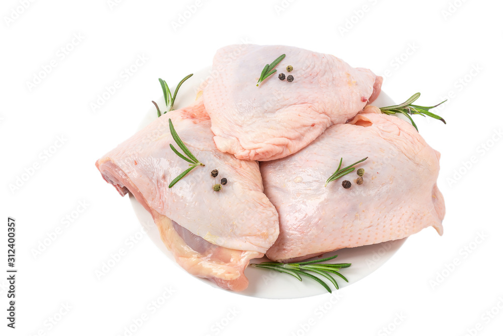 Raw chicken hip meat in a plate with herbs and spices isolated on white background Raw chicken hip meat in a plate with herbs and spices isolated on white background