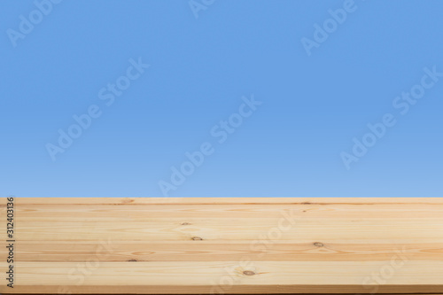 Wooden table in front of a blurred background. Perspective brown wood with blurry grunge or old wall backdrop - can be used to showcase or mount your products. Mock up to display the product.