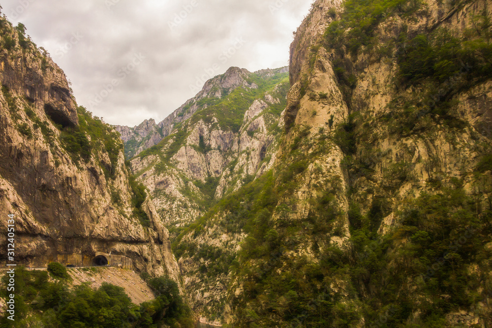 Views of road trough tunnels, canyons, mountains and forests in the Durmitor nature park, Montenegro