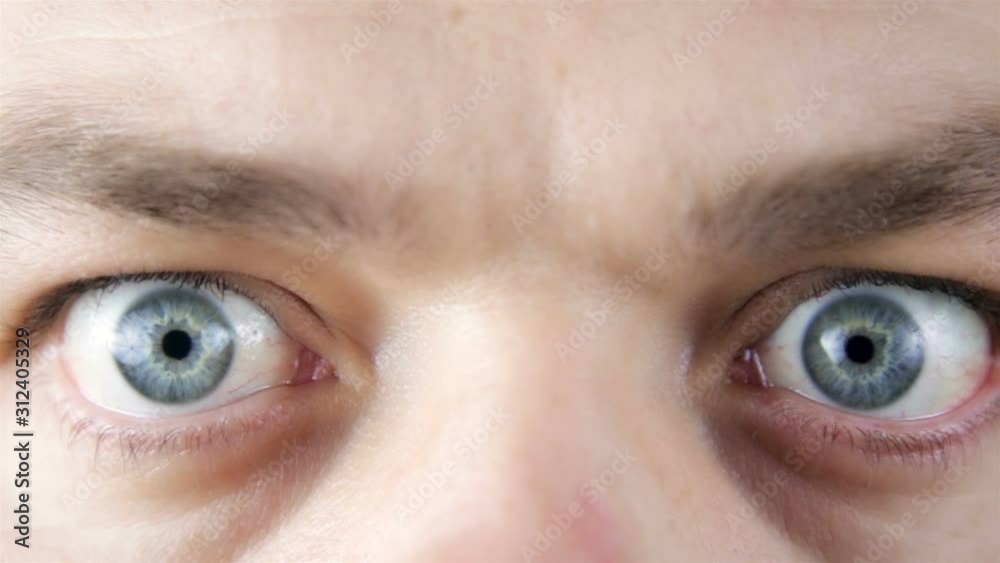 Close up of the eyes of a pretty young man in a surprise or fear expression Close up of the eyes of a pretty young man in a surprise or fear expression
