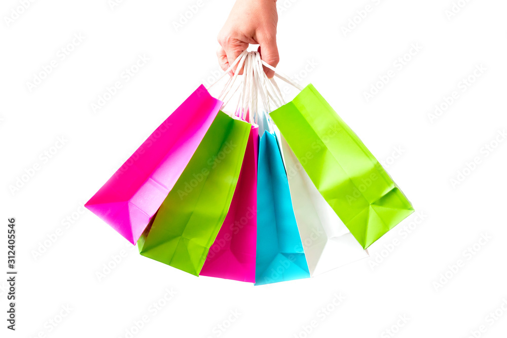 Many packages with purchases are isolated on a white background. A bunch of colored shopping bags is in the hand. Concept of children's shopping, discounts and sale.