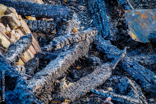 Ruins after the fire, burnt pieces of wood, beams, coal. Consequences of fire accident. © Viesturs
