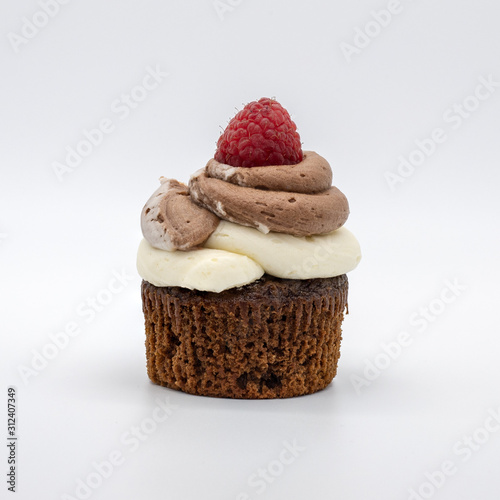 chocolate cupcake with frosting and raspberry garnish