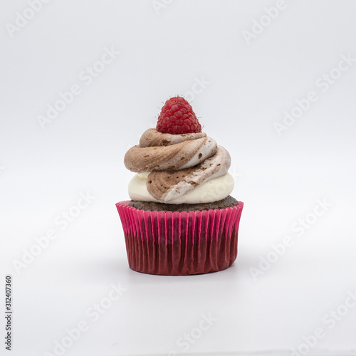 chocolate cupcake with frosting and raspberry garnish