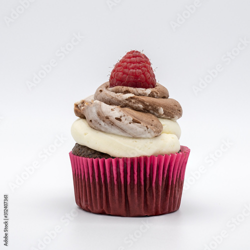 chocolate cupcake with frosting and raspberry garnish