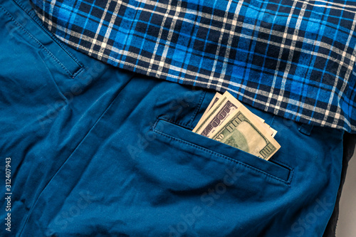 close up dollar cash money corrency in the pants, income earnings photo