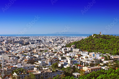 Philopappus hill and monument (right) and cityscape of Athens, Greece photo