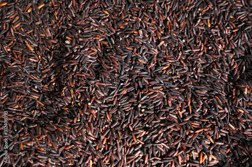 Thai black jasmine rice for food texture  Rice berry . Selective focus