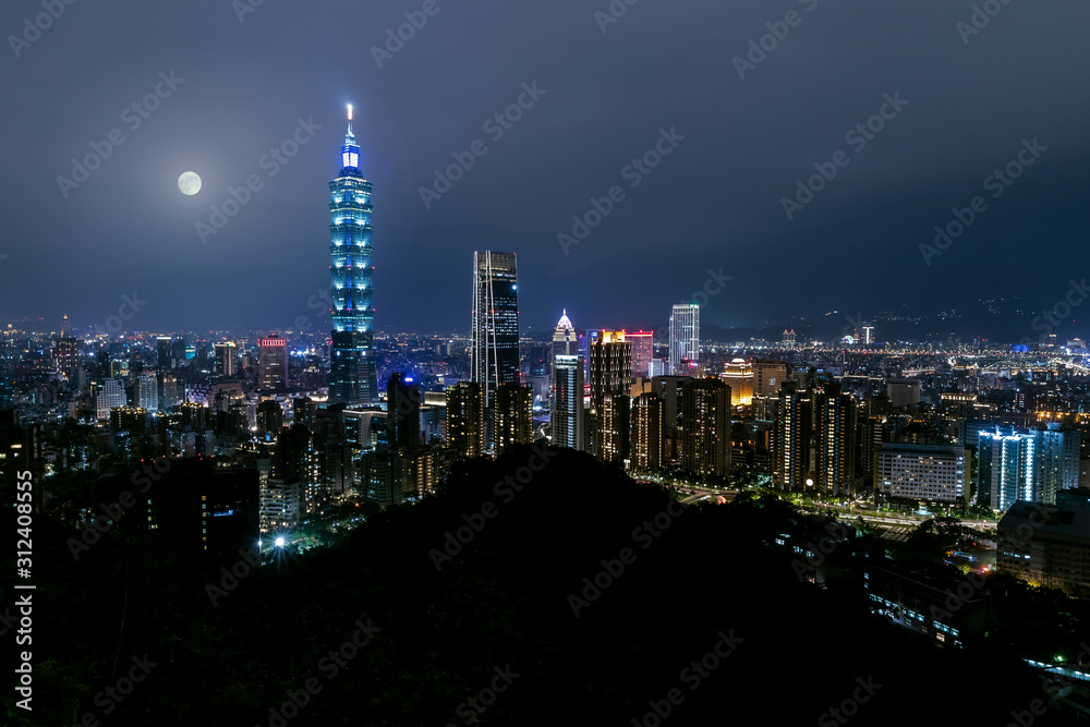 Naklejka premium Beautiful nighttime skyline aerial view of taipei taiwan during full moon with bright city lights, blue theme