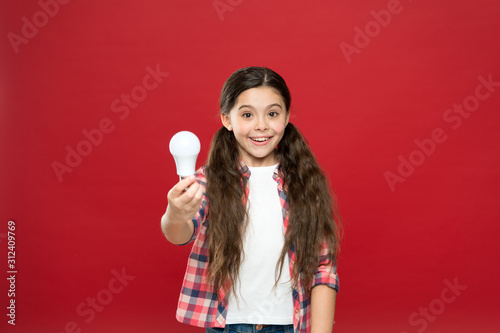 child hold light idea bulb. education concept. good thought solution. small school kid red background. small girl lightbulb. energy and electricity. creating a great idea. Thinking child girl. littl