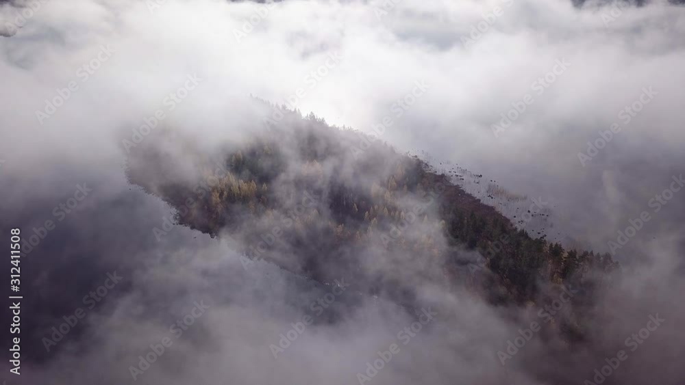 Aerial view of fog moving over island during sunrise Aerial view of fog moving over island during sunrise