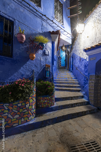 Traditional and typical moroccan architectural details in Chefchaouen, Morocco Africa Narrow and beautiful street of blue medina with blue walls and decorated with various objects. Nice doors, windows © Michal