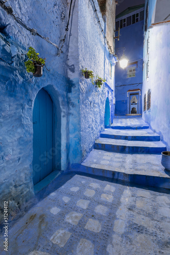 Traditional and typical moroccan architectural details in Chefchaouen, Morocco Africa Narrow and beautiful street of blue medina with blue walls and decorated with various objects. Nice doors, windows