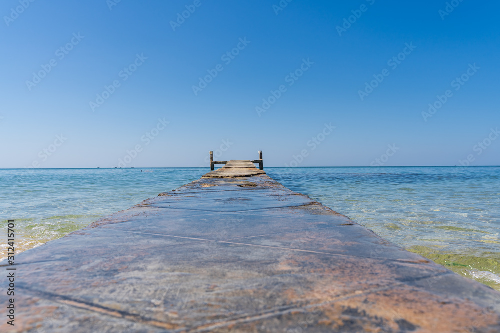 Wooden bridge in the middle of the ocean