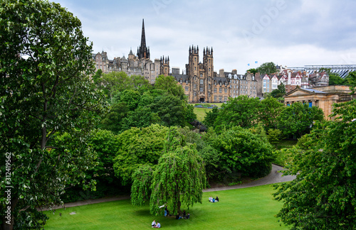 View of the park in the central Edinburgh, Scotland, looking towards the Mound, an artificial hill that connects Old and New Towns, with the Hub, New College and National Gallery of Scotland