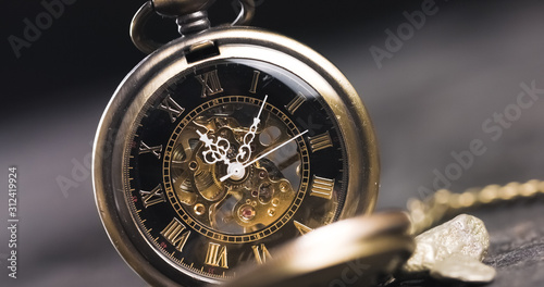 Antique old pocket watch dial close-up. Vintage hipster clock measuring time.