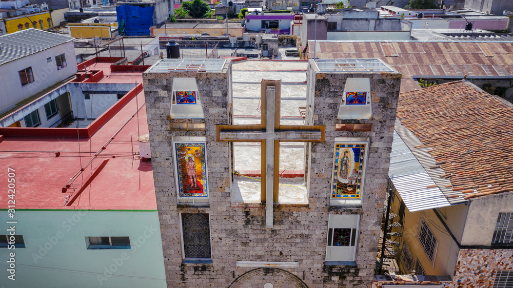 Cross and religious stained glass windows on church Señor del Consuelo in Tepic, Nayarit. Mexico art and culture. Aerial drone view.