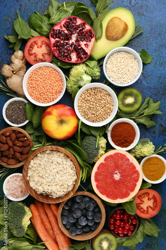 Healthy food clean eating selection  fruit  vegetable  seeds  superfood  cereals  leaf vegetable on rustic background