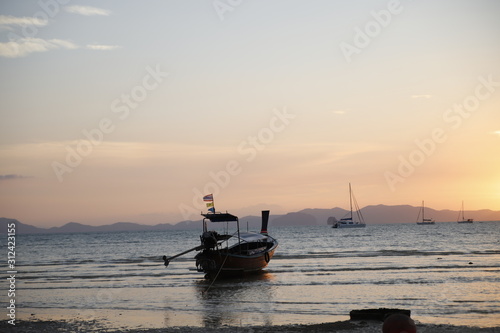 Sunset in the beach with a boat, Thailand 