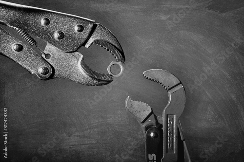 Creative image of plumbing wrenches as birds on gray background