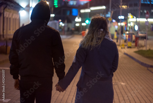 people walking on city street at night