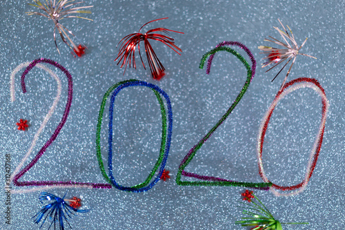 2020 New Years postcard with festive multicolored pipe cleaners.