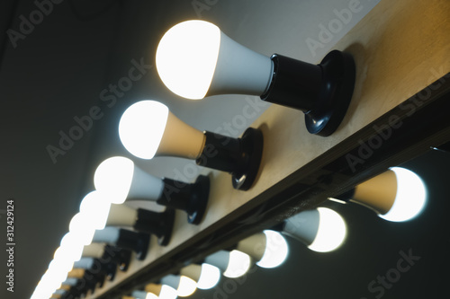 bright lamps in a row on the make-up mirror for makeup artists and actors
