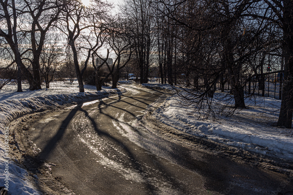 2019.02.19, Moscow, Russia. ice covered road glistens in the bright sun on a frosty day. Walking around Kolomenskoye park. 2019.02.19, Moscow, Russia. ice covered road glistens in the bright sun on a frosty day. Walking around Kolomenskoye park.
