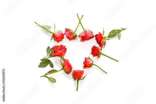 Fototapeta Naklejka Na Ścianę i Meble -  red roses laid in a heart shape isolated on a white background, love concept with copy space