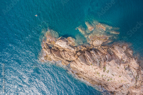 aerial view of the rocky cape surrounded by turquoise water