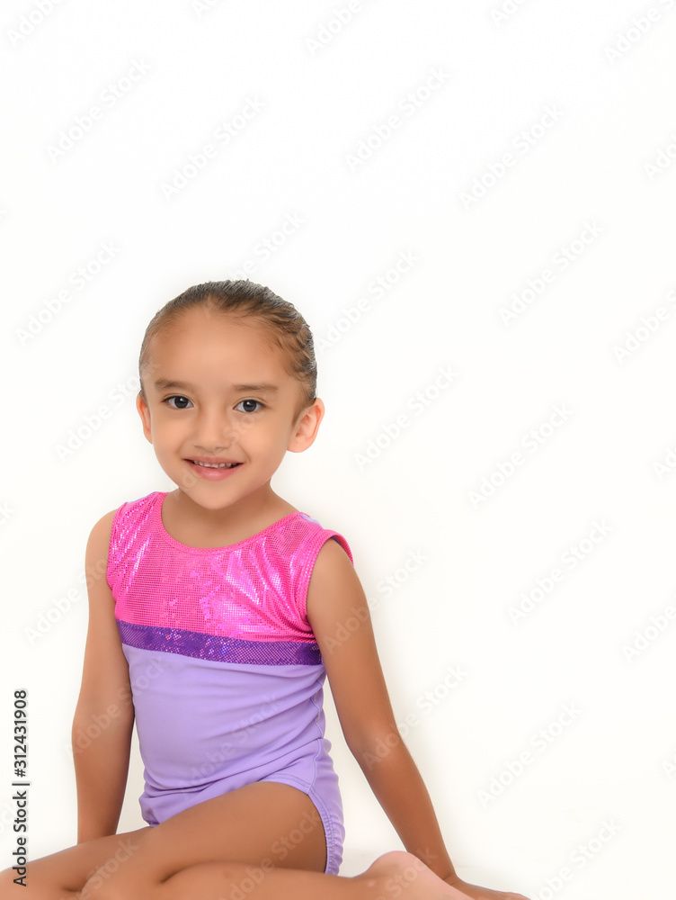 small latin girl doing gymnastics with white background and purple sportswear small latin girl doing gymnastics with white background and purple sportswear