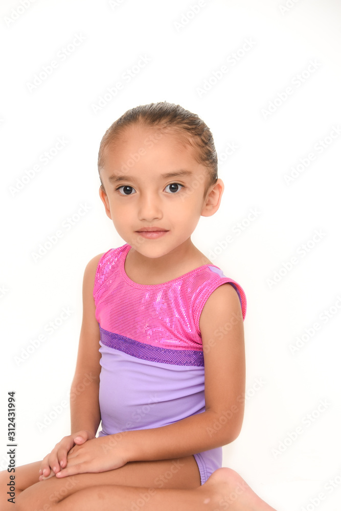small latin girl doing gymnastics with white background and purple sportswear small latin girl doing gymnastics with white background and purple sportswear
