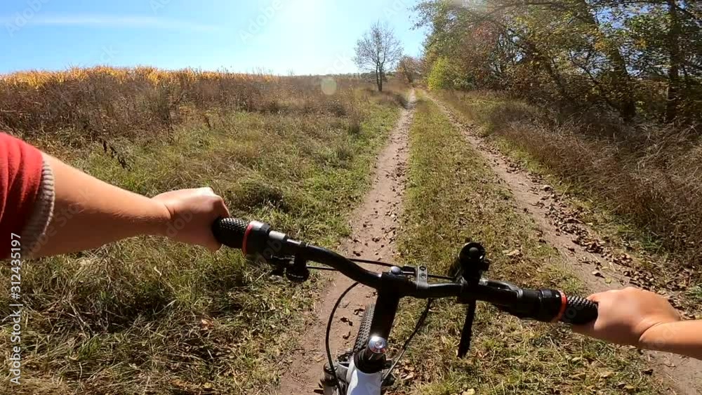 Girl rides bicycle through forest. A man on a bicycle rides in forest Girl rides bicycle through forest. A man on a bicycle rides in forest