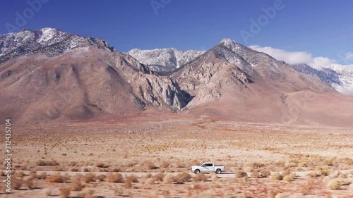 Aerial Drone Tracking a Pickup Truck with Mountains in Death valley Nevada USA