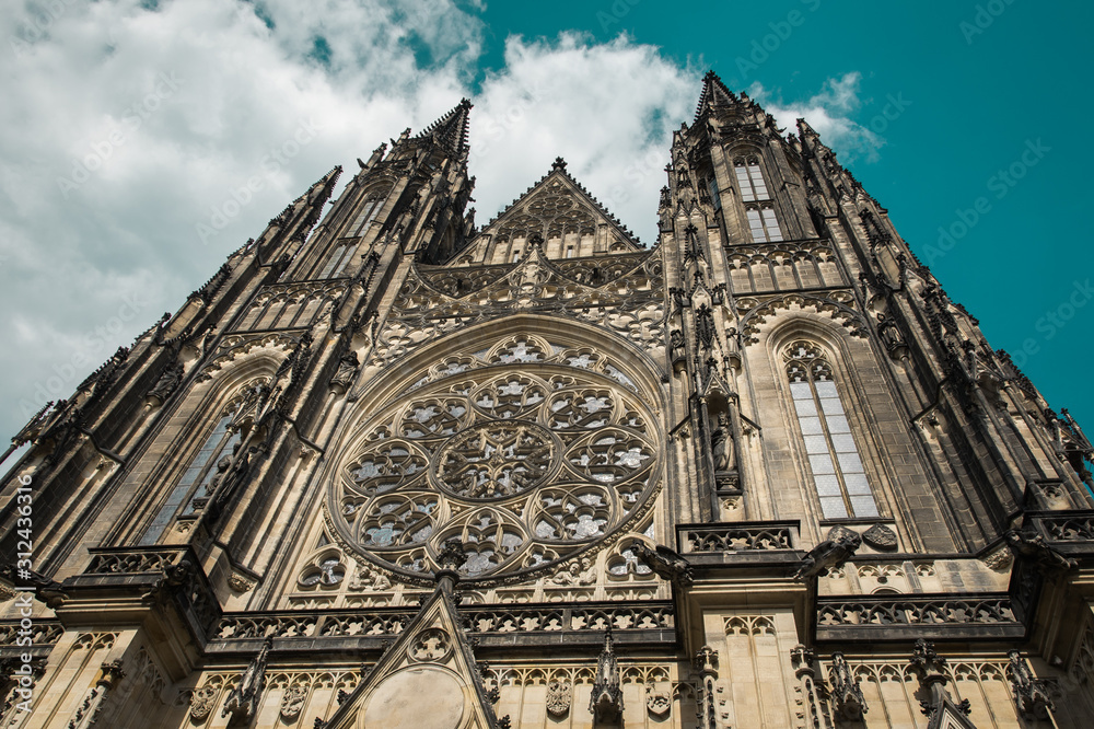 Stunning gothic Saint Vitus Cathedral against teal blue cloudy sky (Czech: Chram Svateho Vita, Prazsky Hrad), seat of the Archbishop of Prague - Roman Catholic Church - Prague Castle complex