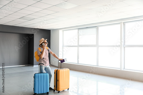Young man with luggage at t...