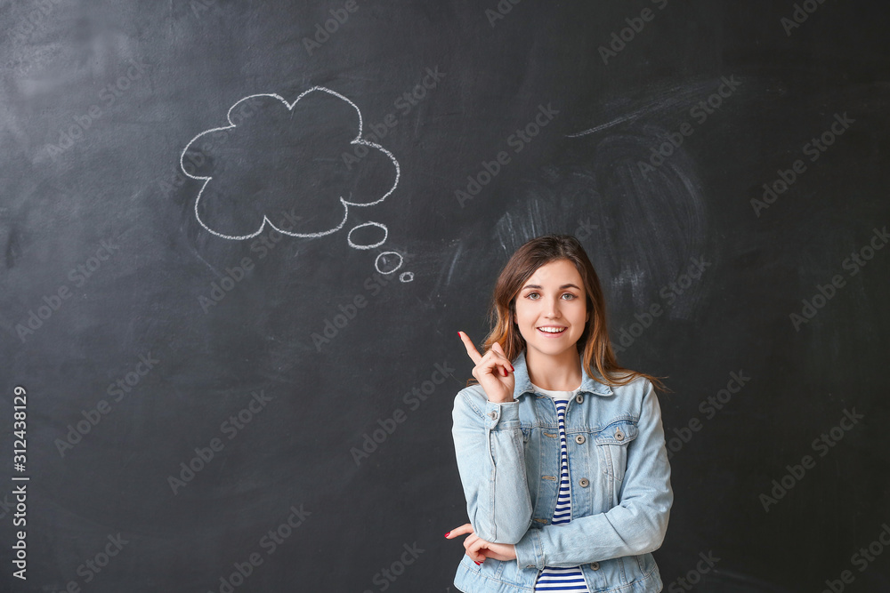 Young woman with blank speech bubble on dark background