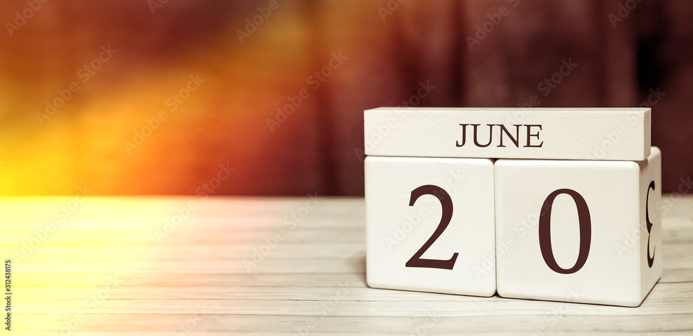 Calendar reminder event concept. Wooden cubes with numbers and month on June 20 with sunlight. Calendar reminder event concept. Wooden cubes with numbers and month on June 20 with sunlight.