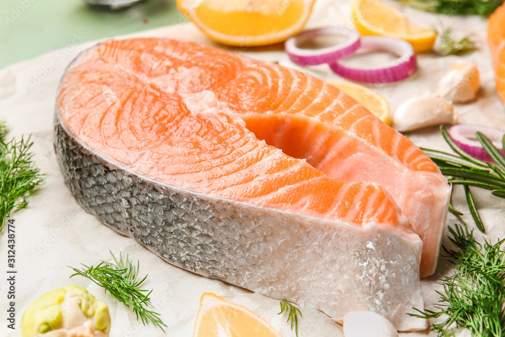 Raw salmon steak on table