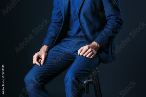 Man in stylish blue clothes on dark background